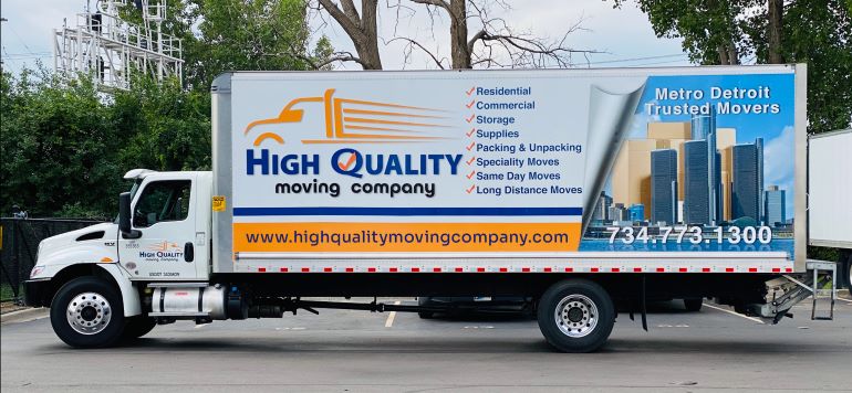 High Quality Moving Company truck, with list of services on it.