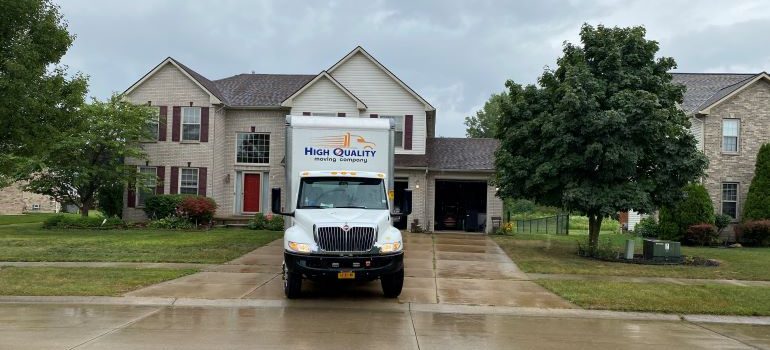 High Quality Moving Company truck in front of a house.