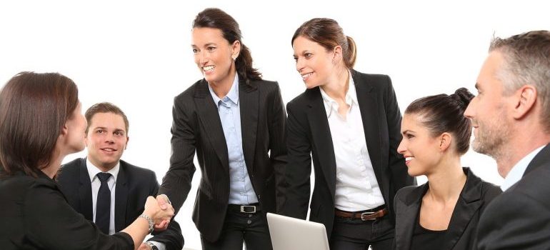 Businesswoman shaking hands - recognize high quality moving companies