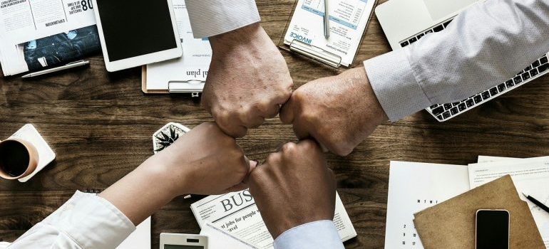 A group of people fist-bumping.