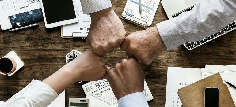 people fist bumping as a symbol of teamwork