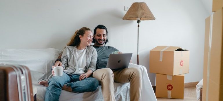 Couple laughing and looking at laptop