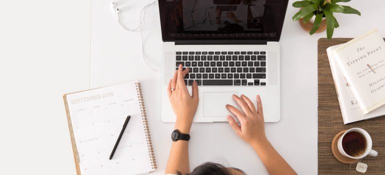 a girl typing on a laptop