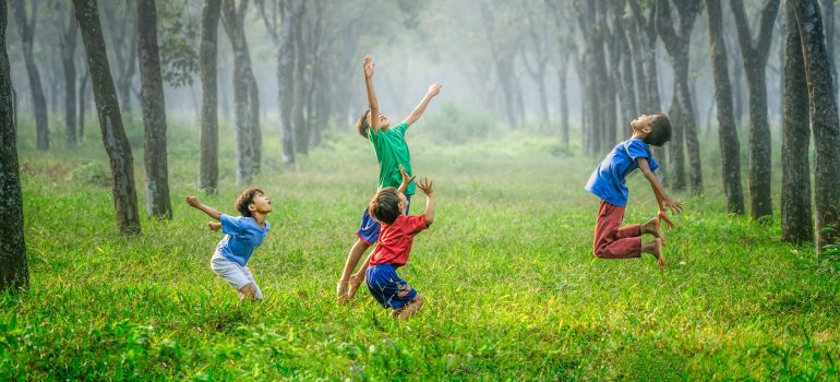 Kids jumping in the field