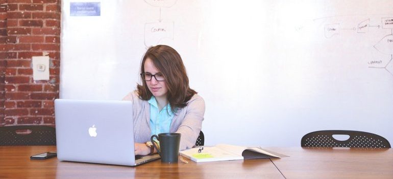 A woman working on a laptop.