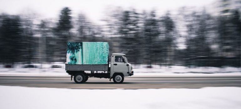 A truck on the road during winter