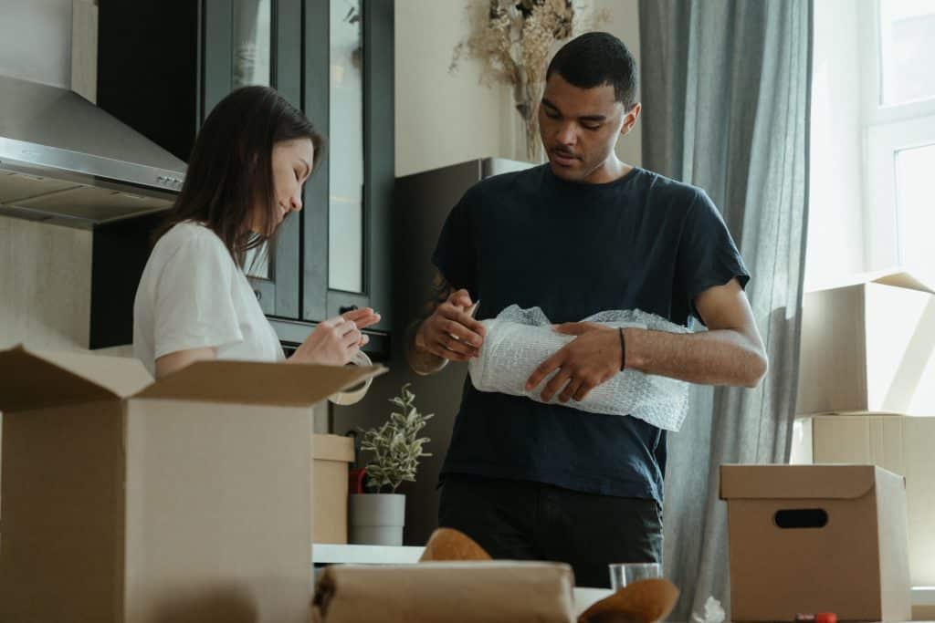 Young couple packing for relocation