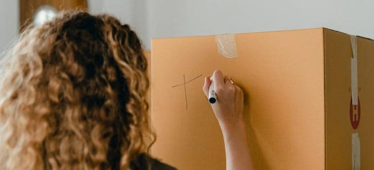 woman labeling a box