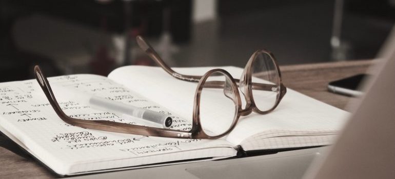 A notebook and glasses.