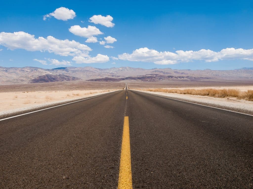 Long highway and clouds