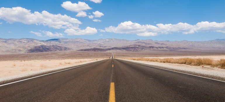 Long highway and clouds