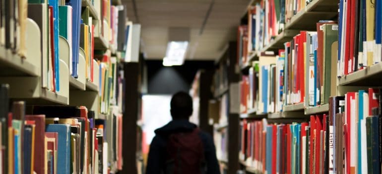 A student walking through a library