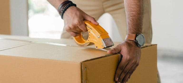 a person sealing the box