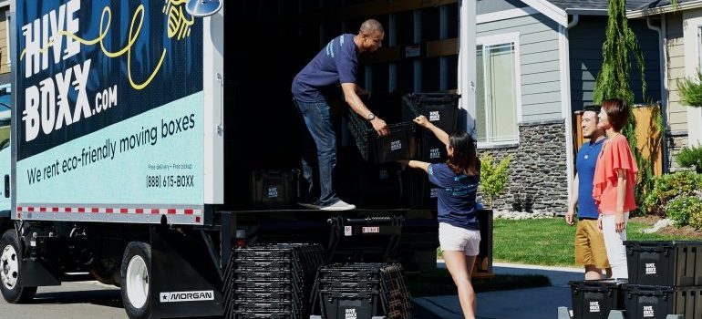 People loading truck for moving to White Lake, MI