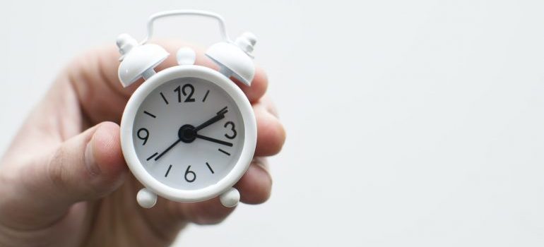 A person holding a clock