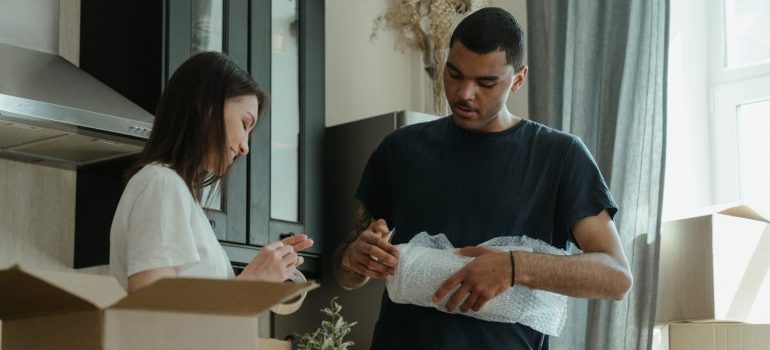 A couple packing an essentials box.