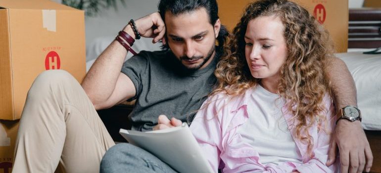 A couple looking at a checklist the night before the move.