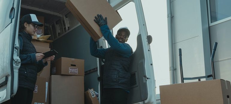 A man taking the box out of the truck