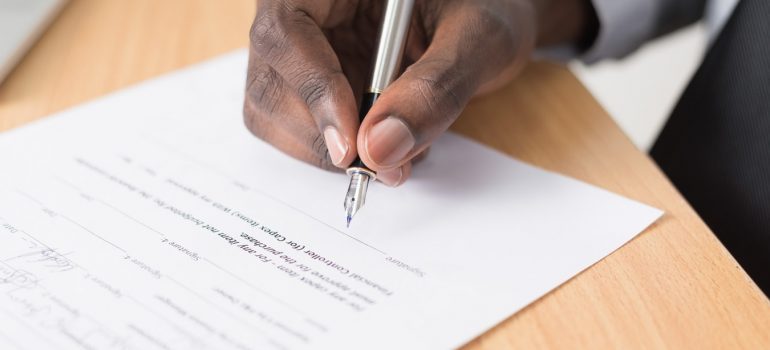 A man signing a document