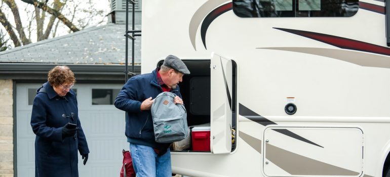 An elderly couple packing