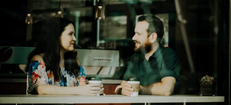 a couple chatting while drinking coffee as one of the first things to do before moving with your partner