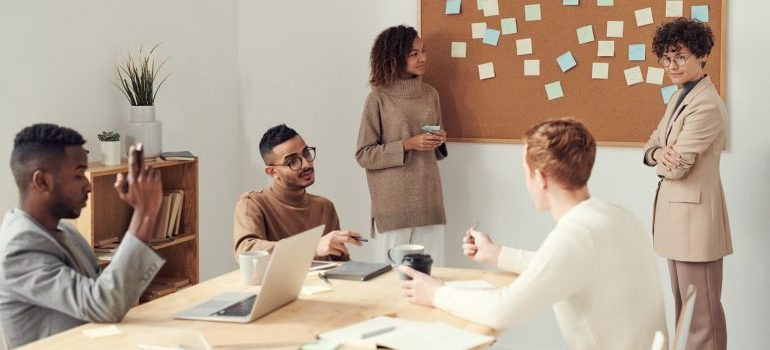 A business owner talking to her employees in a meeting.