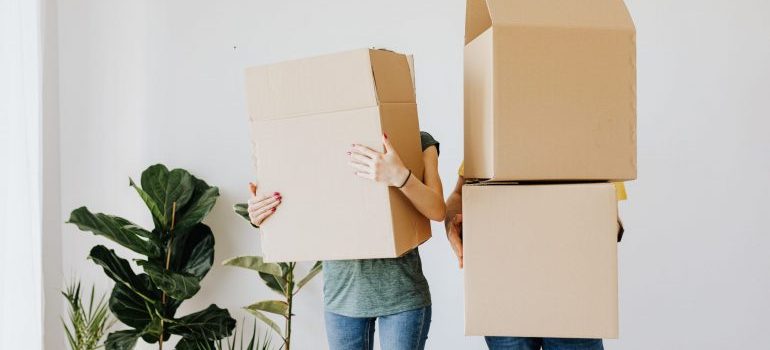 A couple with cardboard boxes.