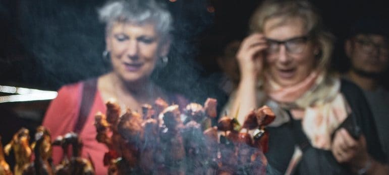 Two people on a bbq stand