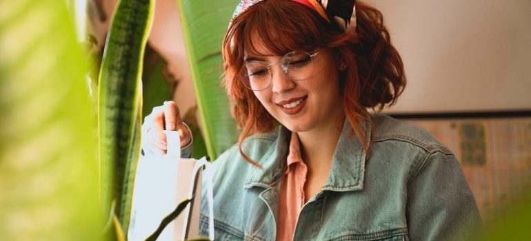 A woman studying a piece of furniture.